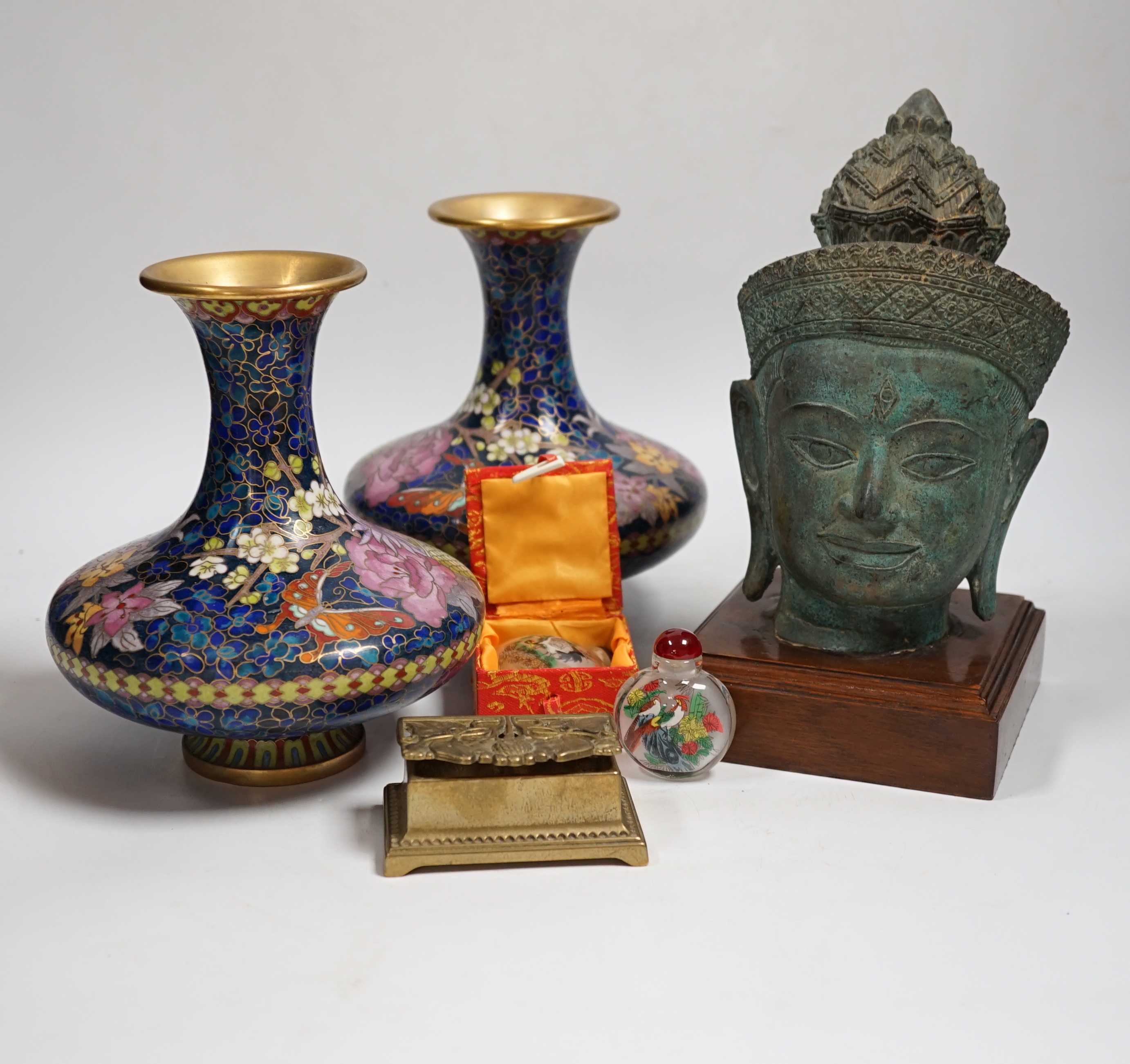 A Thai bronze model of a Buddha head, a pair of Chinese cloisonné vases, reverse painted snuff bottles etc